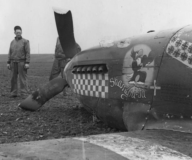Capt. Don Gentile's P-51B Mustang "Shangri-La" after crash landing on 13 April 1944 as Gentile arrived back at the 4th Fighter Group's Debden air base after his last mission. Printed caption attached to print: 'Captain Gentile crashes after big raid over continent, 14.4.44' And: 'Captain Don S. Gentile, 23-year-old flight leader in a U.S. 8th Air Force Mustang Group, who now is the top-scoring American ace in the European Theatre, crash-landed yesterday April 13th [date censored] after taking pa