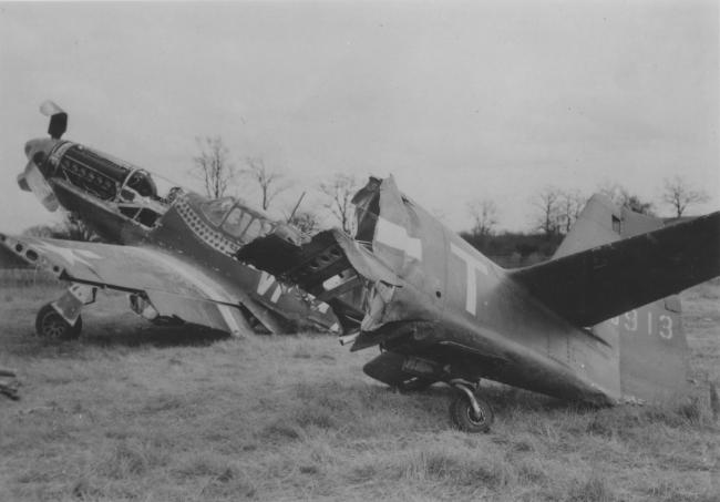 The bisected wreck of a P-51 Mustang (VF-T, serial number 43-6913) nicknamed "Shangri-La", flown by USAAF fighter ace Captain Donald S. Gentile of the 336th Fighter Squadron, 4th Fighter Group. Handwritten caption on reverse: 'Gentile's Mustang. R. Bowers.'